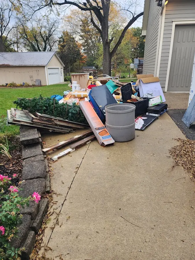 Dumpster being loaded with debris for Roofing Dumpster Rental in David City